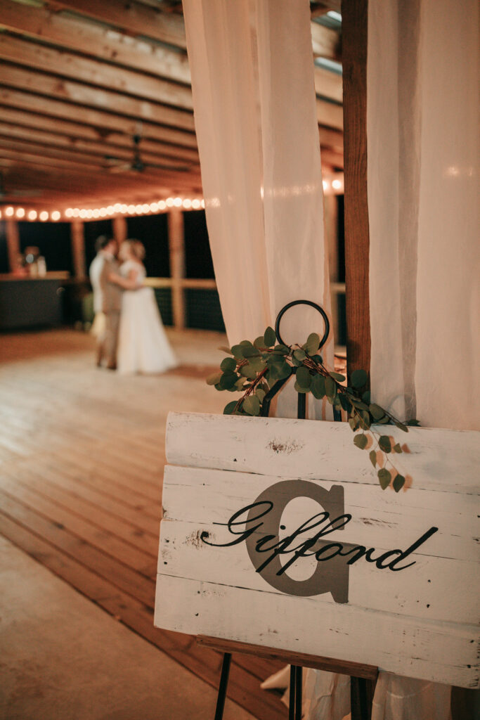 Private last dance under string lights at barn wedding venue